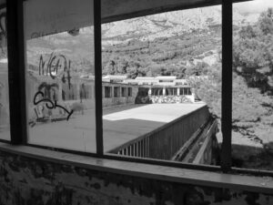 View from inside abandoned building overlooking rooftop courtyard and mountains – nbcreations