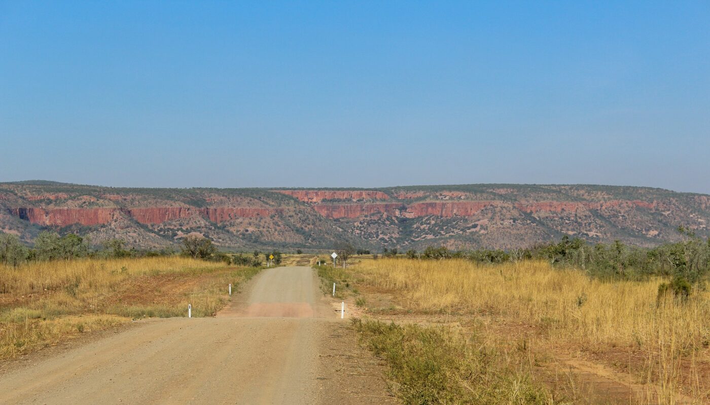 Outback road facing red cliffs in Australia – nbcreations