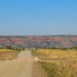 Outback road facing red cliffs in Australia – nbcreations