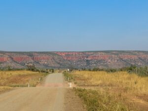 Outback road facing red cliffs in Australia – nbcreations