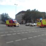 Two ambulances with flashing blue lights at a city intersection, image blurred – emergency urban scene - nbcreations