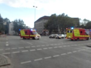 Two ambulances with flashing blue lights at a city intersection, image blurred – emergency urban scene - nbcreations