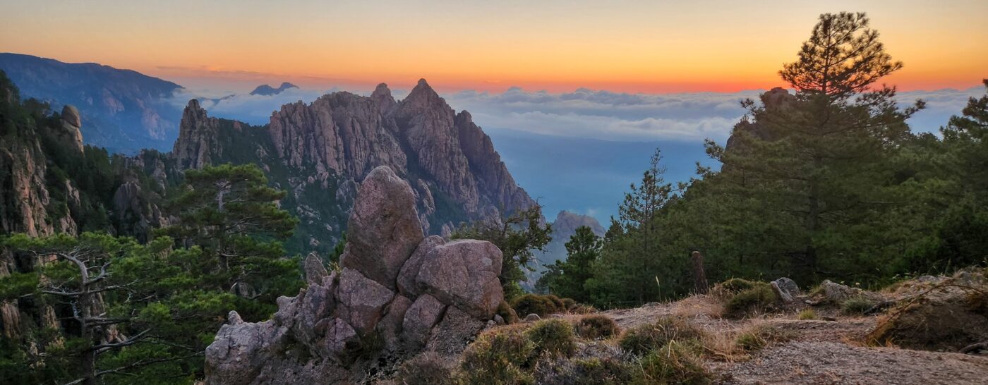 Sunset over the Bavella Needles with dramatic rock formations, pine trees, and colorful sky – Corsican mountain landscape - nbcreations