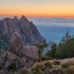 Sunset over the Bavella Needles with dramatic rock formations, pine trees, and colorful sky – Corsican mountain landscape - nbcreations