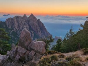 Sunset over the Bavella Needles with dramatic rock formations, pine trees, and colorful sky – Corsican mountain landscape - nbcreations
