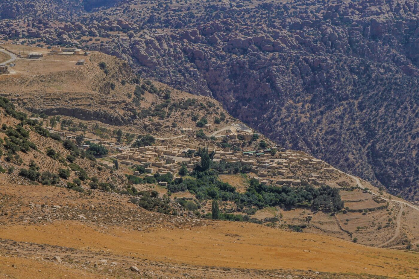 Upward view of Dana village with stone houses under bright daylight – Jordanian hillside architecture - nbcreations