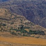 Upward view of Dana village with stone houses under bright daylight – Jordanian hillside architecture - nbcreations