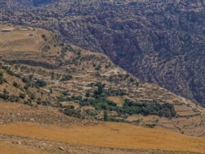 Upward view of Dana village with stone houses under bright daylight – Jordanian hillside architecture - nbcreations