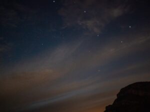 Halo of moonlight diffused by clouds in a dark night sky – abstract nocturnal light - nbcreations