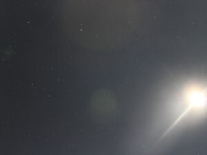 Full moon with shining lunar rays and a starry sky in the background – celestial nightscape - nbcreations