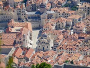 Steep stone staircase descending into Dubrovnik’s old town with terracotta rooftops and stone walls – Croatian historic cityscape - nbcreations