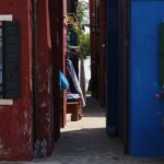 Street in Murano with colorful buildings and cobblestone pavement – Venetian island atmosphere - nbcreations