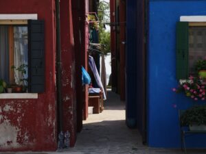 Street in Murano with colorful buildings and cobblestone pavement – Venetian island atmosphere - nbcreations