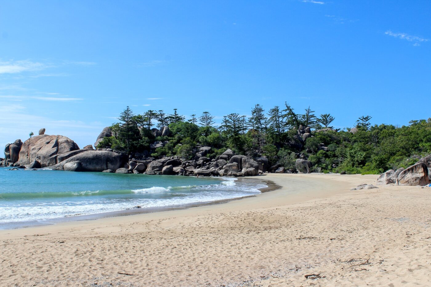 Sandy beach with large rocks and calm water – tranquil coastal landscape - nbcreations