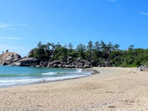 Sandy beach with large rocks and calm water – tranquil coastal landscape - nbcreations