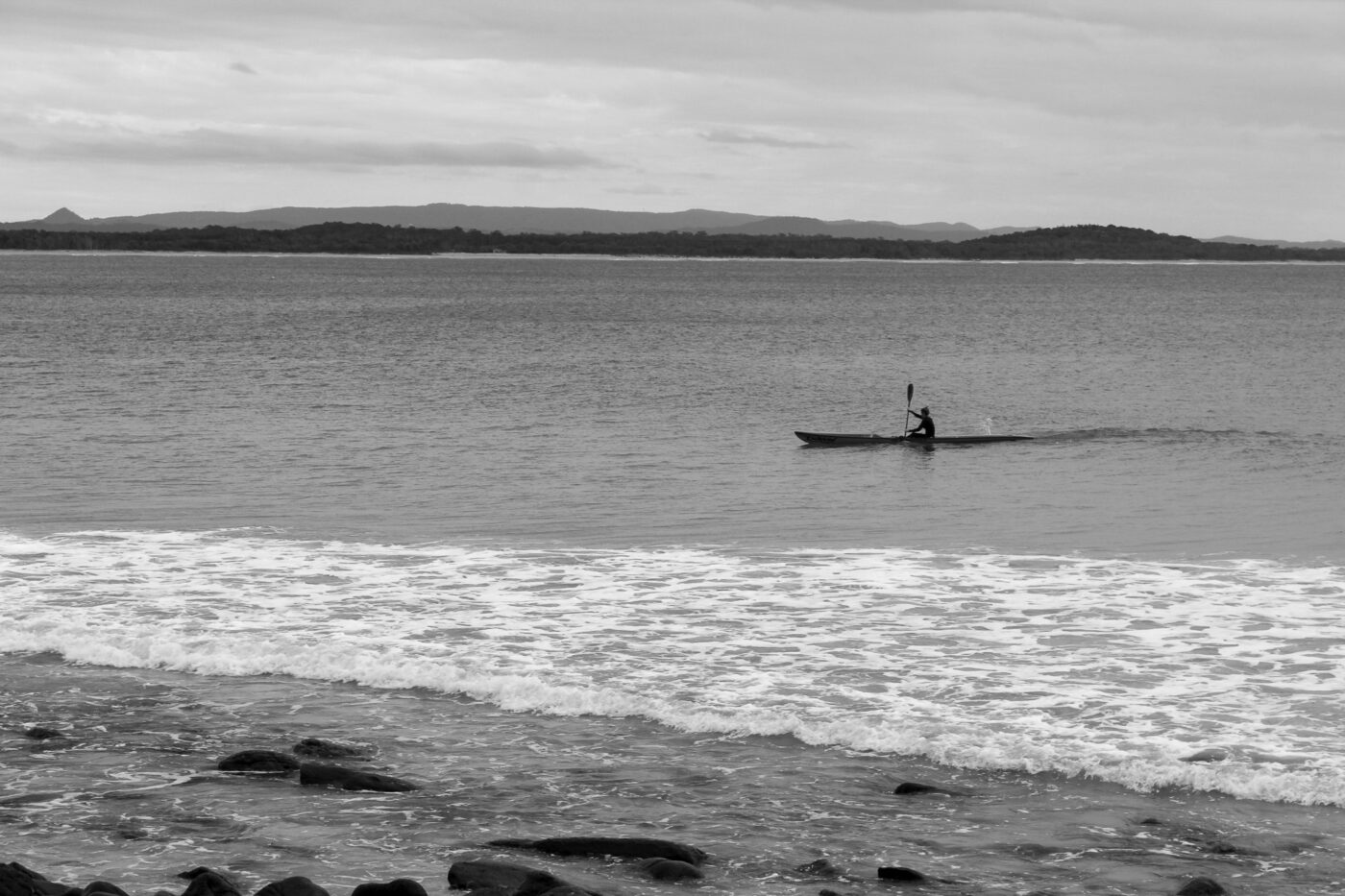 Person kayaking alone on calm water – tranquil solo adventure - nbcreations