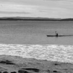 Person kayaking alone on calm water – tranquil solo adventure - nbcreations