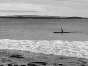 Person kayaking alone on calm water – tranquil solo adventure - nbcreations