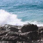 Wave crashing against coastal rocks – dynamic seashore scene - nbcreations