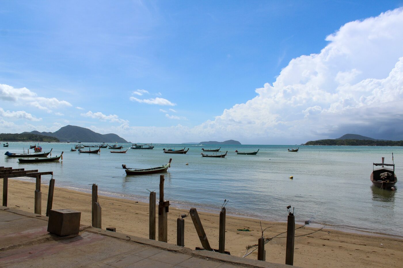 Thai beach with boats floating on the sea – tropical coastline in Thailand - nbcreations