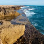 Low two-tiered cliff coastline resembling stone steps, with the sea in the foreground – unique coastal formation - nbcreations