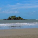 Small island seen from a sandy beach – coastal seascape view - nbcreations