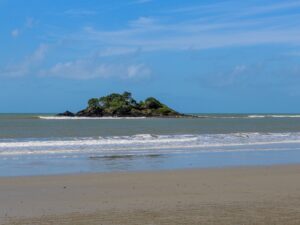 Small island seen from a sandy beach – coastal seascape view - nbcreations