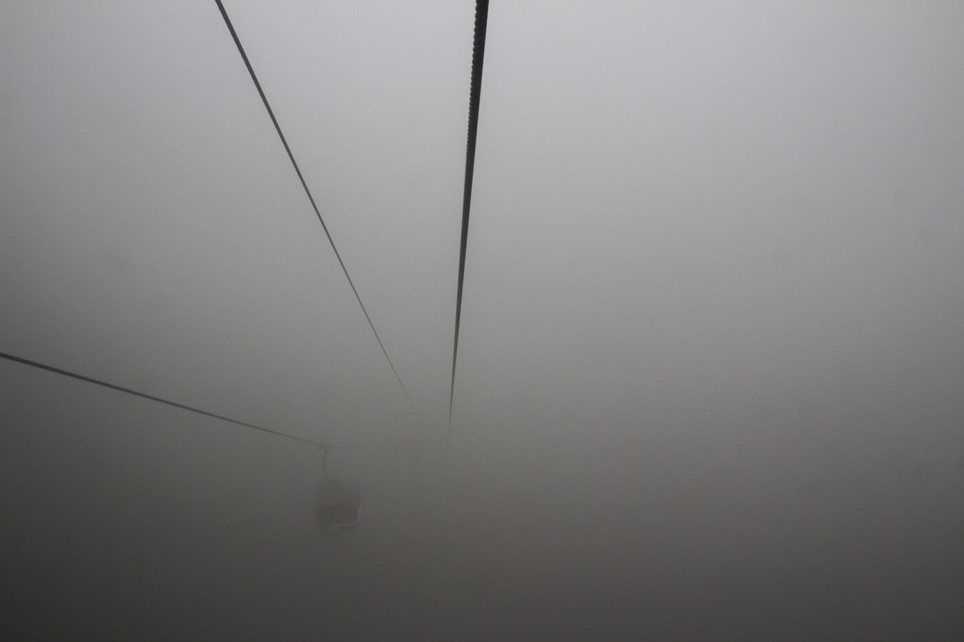 Cable car suspended in thick fog – atmospheric aerial transport - nbcreations