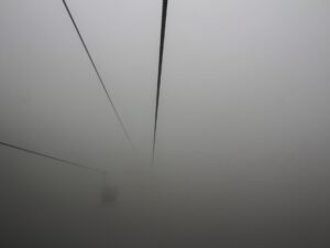 Cable car suspended in thick fog – atmospheric aerial transport - nbcreations