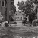 Quiet town square with empty benches and surrounding buildings – peaceful urban space - nbcreations