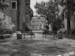 Quiet town square with empty benches and surrounding buildings – peaceful urban space - nbcreations