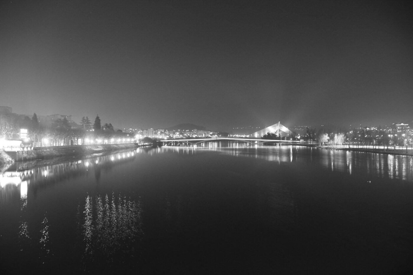 City bridge illuminated at night with reflections on the water – urban nightscape - nbcreations