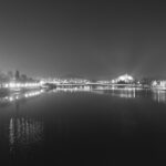 City bridge illuminated at night with reflections on the water – urban nightscape - nbcreations