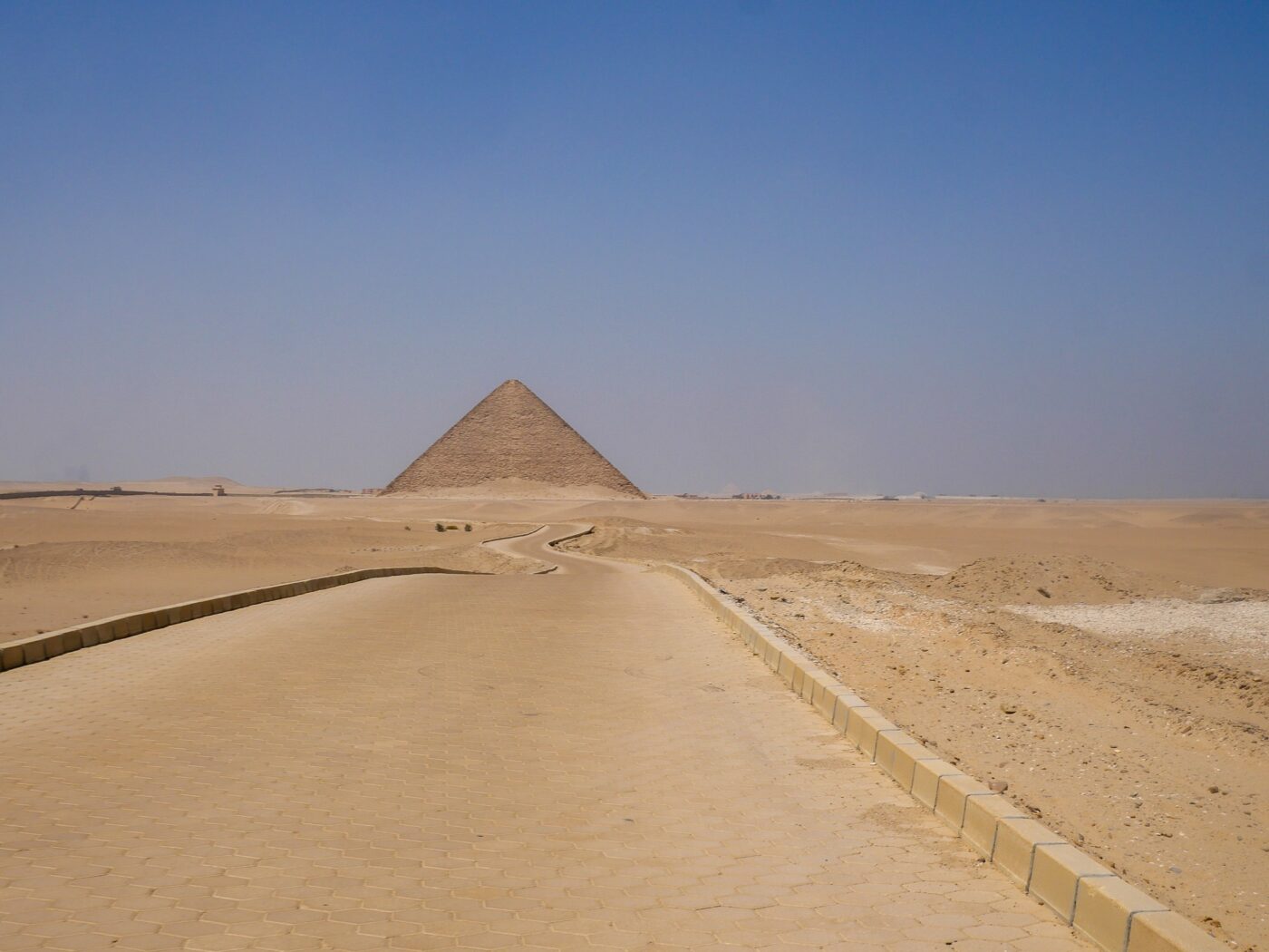 Pathway leading toward an Egyptian pyramid in the desert – ancient monument approach - nbcreations