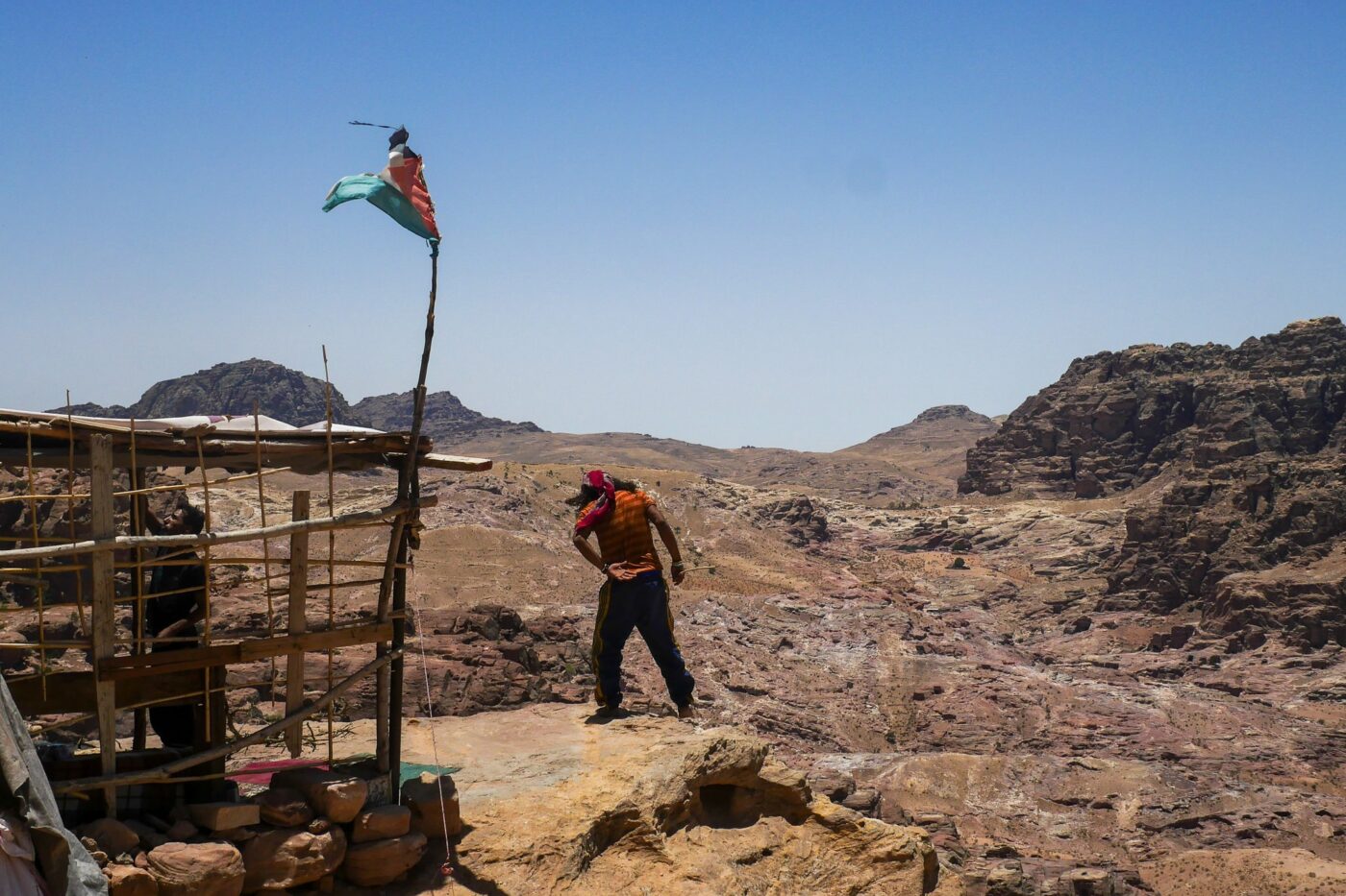 View of Petra valley in Jordan with man standing groggy, looking out over the landscape – archaeological site - nbcreations