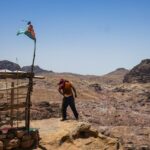 View of Petra valley in Jordan with man standing groggy, looking out over the landscape – archaeological site - nbcreations