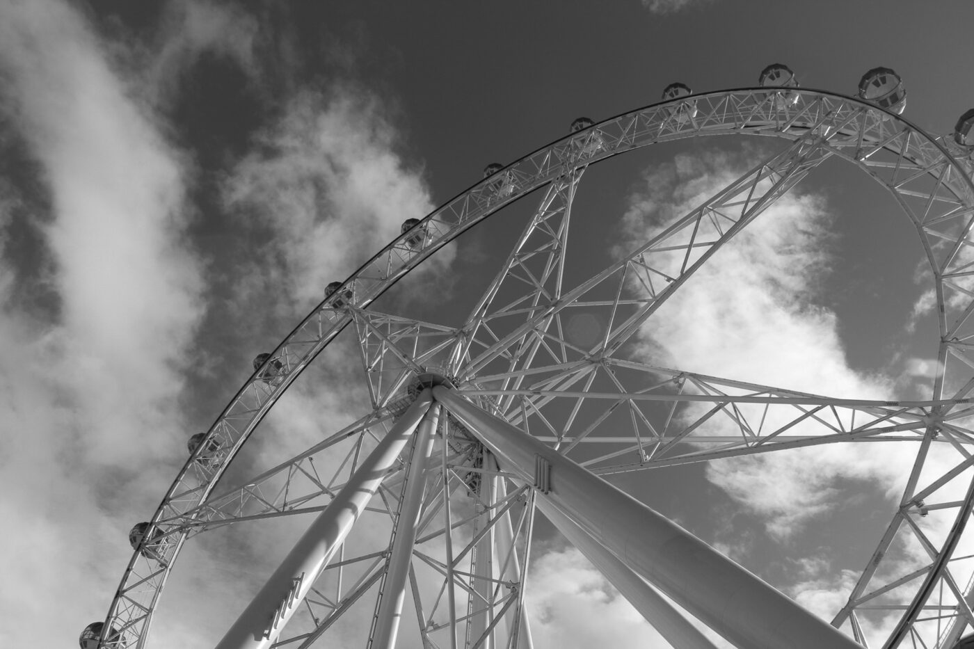 Black and white view of Ferris wheel from below during daytime – dramatic upward angle - nbcreations