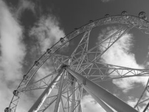 Black and white view of Ferris wheel from below during daytime – dramatic upward angle - nbcreations