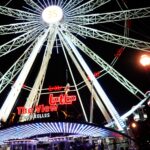 Ferris wheel illuminated at night in an amusement park – festive lights - nbcreations