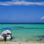 Small boat floating on turquoise water near Santo Domingo – Caribbean seascape - nbcreations