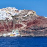 White-washed buildings and blue domes overlooking the sea in Santorini – iconic Greek island view - nbcreations