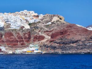 White-washed buildings and blue domes overlooking the sea in Santorini – iconic Greek island view - nbcreations