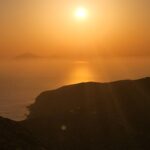 Golden sunset over calm ocean horizon nbcreations