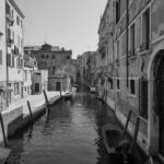 Scenic canal view in Venice with small traditionnal boat– Italian cityscape - nbcreations