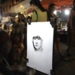 Street artist drawing portrait at night NBCcréations