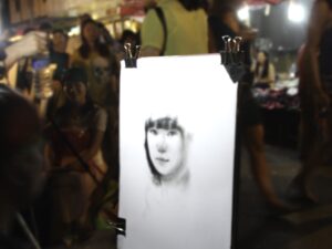 Street artist drawing portrait at night NBCcréations