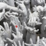 White sculpted hands reaching upward, one with a red fingernail – nbcreations