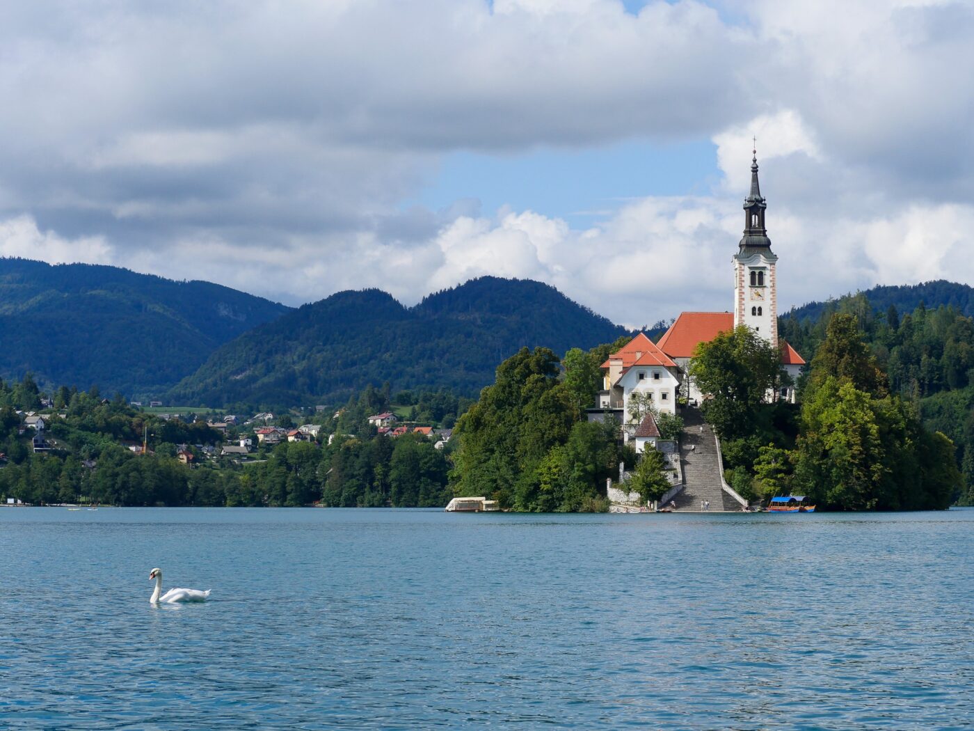 Church on the island of Lake Bled with a swan on the water – nbcreations