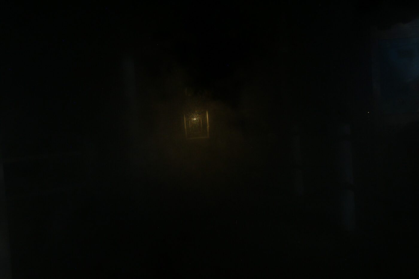 Dimly lit lantern at the end of a dark, misty corridor – mysterious nocturnal scene - nbcreations