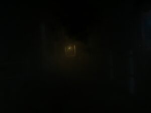 Dimly lit lantern at the end of a dark, misty corridor – mysterious nocturnal scene - nbcreations
